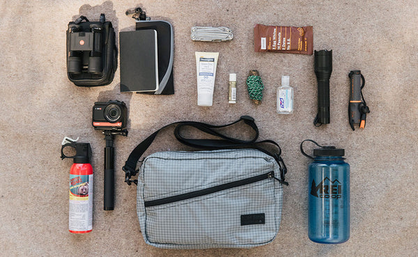 Design Lab Edition Packing Cube Shoulder Bag in Northwest Sky with items around it.